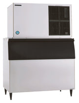 A large Hoshizaki commercial ice maker with a white metal body, black vented panel on the upper section, and a black front-loading ice storage bin below. It produces Crescent Cube ice and stands on four legs, with a certification sticker on the upper left.