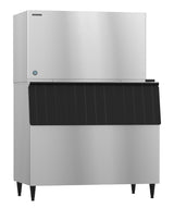 A Hoshizaki ice maker with a stainless steel body and four legs. The top rectangular section produces crescent cube ice, while the lower bin features a black, ridged front panel for easy storage and dispensing.
