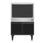 A Hoshizaki ice maker with a silver stainless steel top, large black dispenser door, and black vented lower section. The machine stands on four legs and features a blue and white circular logo, producing crescent cube ice.