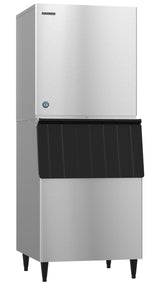 A Hoshizaki commercial ice maker with a stainless steel finish stands on four legs. Its upper section produces Crescent Cube ice, while the lower section features a black-lidded storage bin—ideal for professional kitchens or businesses.