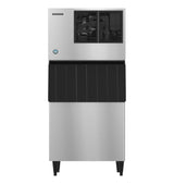 A commercial Hoshizaki stainless steel ice maker with a rectangular shape, black vented top panel, black lower door, and four black legs. This cube-style machine has a clean, industrial look and is built for high-volume ice production.
