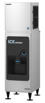 A commercial Hoshizaki stainless steel ice dispenser stands on four short legs. The black front panel displays ICE DISPENSER in white and blue. The recessed dispensing area features a blue-lit sensor for filling cups with cube-style ice.
