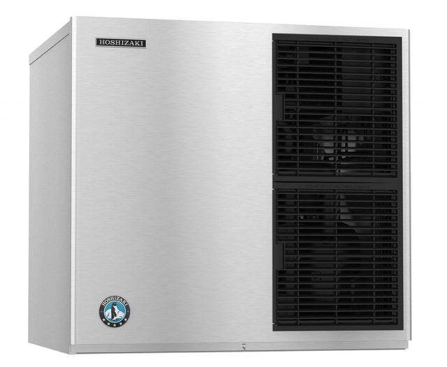 A stainless steel Hoshizaki ice maker with a cube-style design features two black vented sections on the front panel and a round blue and white penguin logo on the lower left, giving it a sleek, industrial look.