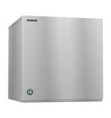 A large, box-shaped Hoshizaki ice maker with a sleek, brushed stainless steel exterior. The front panel is flat, featuring a small manufacturer’s logo in the top left and a circular blue emblem in the bottom left corner. Produces crescent cube ice.