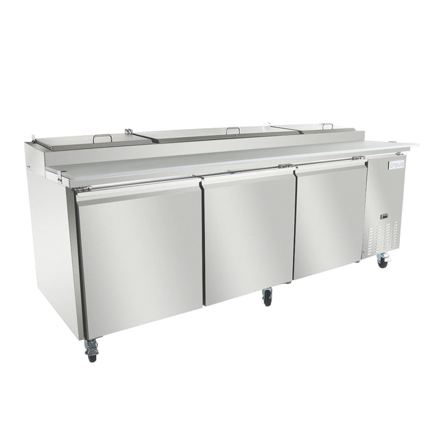 A large stainless steel refrigerated prep table with three doors and wheels. The unit features a flat workspace on top with covered compartments, ideal for preparing and storing food ingredients in a professional kitchen setting.