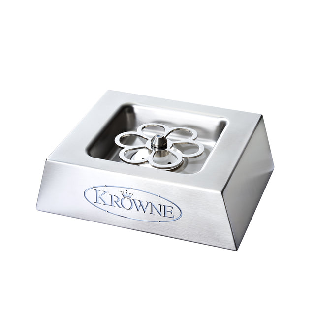 A stainless steel countertop glass rinser with a sloped square base, featuring the Krowne logo and a central star-shaped spray nozzle for rinsing glasses. Pair with a CO2 glass chiller for spotless, chilled glasses in any bar or kitchen setting.