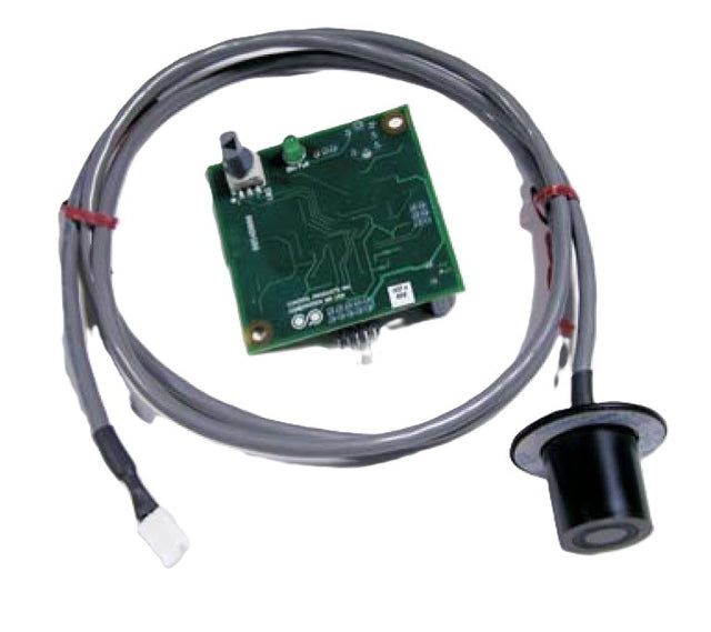 A green circuit board with electronic components sits beside a long gray cable, partially secured with red ties, designed for Scotsman Prodigy Vari-Smart Ice Level Control systems to monitor and maintain precise ice bin levels.