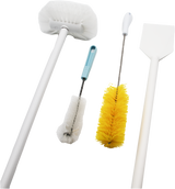 Four cleaning brushes from a clean-up kit are shown on a white background: a white toilet brush with handle, a small white bottle brush with blue handle, a yellow bottle brush, and a white paddle scraper-shaped cleaning tool.
