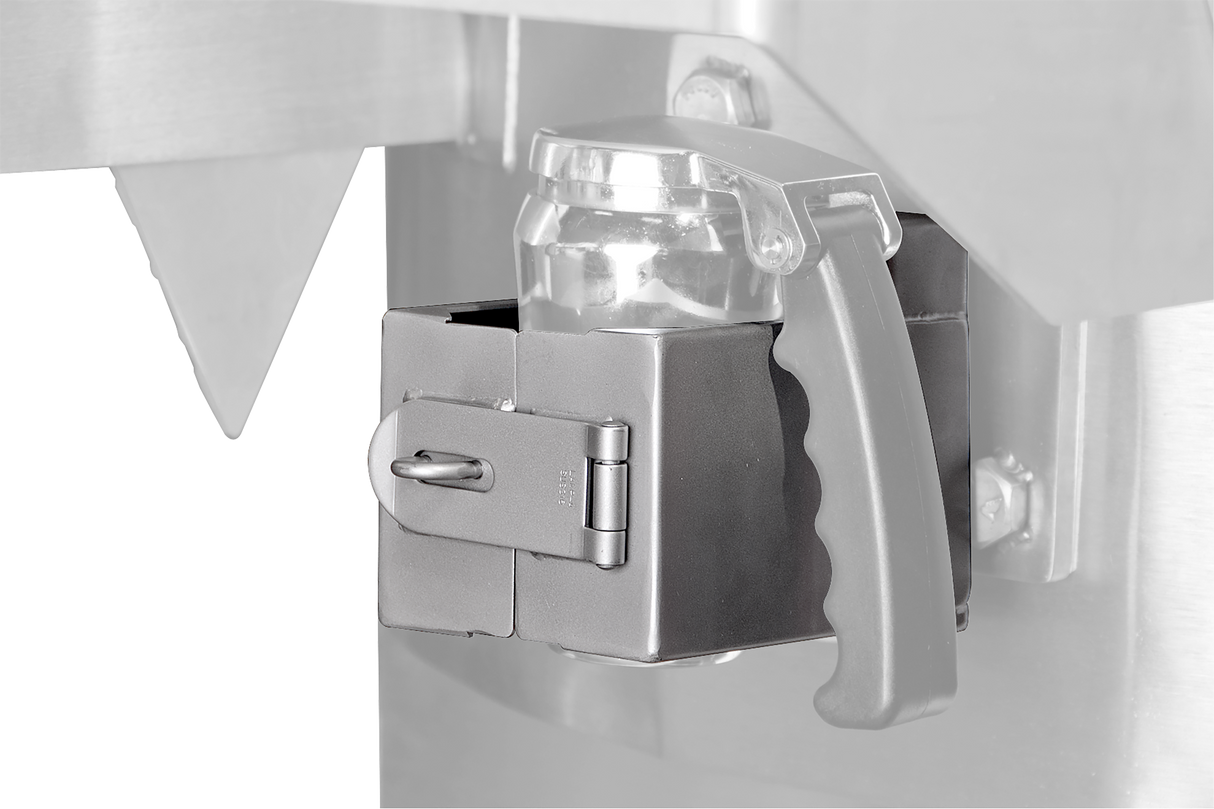 Close-up of a metallic safety latch securing a transparent plastic container with a black handle to a Vulcan stainless steel machine, featuring a hinged latch locked by a metal pin. The background is mostly out of focus.