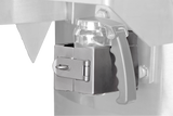 Close-up of a metallic safety latch securing a transparent plastic container with a black handle to a Vulcan stainless steel machine, featuring a hinged latch locked by a metal pin. The background is mostly out of focus.