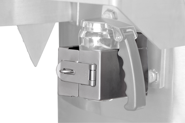 Close-up of a metallic safety latch securing a transparent plastic container with a black handle to a Vulcan stainless steel machine, featuring a hinged latch locked by a metal pin. The background is mostly out of focus.