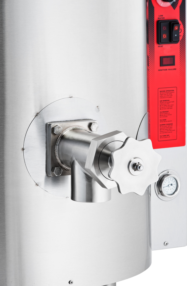 Close-up of a stainless steel industrial tank or boiler, featuring a large, star-shaped 3 inch valve handle and spout. A pressure gauge and red control panel with buttons and instructions appear on the right side of the image.