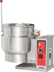 A large, stainless steel Vulcan 12-gallon Tilting Kettle with a control panel featuring dials, switches, and a temperature gauge. The kettle includes capacity markings, a spout, and a tall red lever at the base of the control box.
