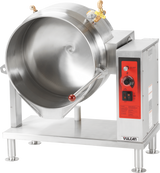 A large, industrial tilting kettle with stainless steel construction features a deep circular basin, red tilting handle, control knobs, gauges, and indicator lights on a red panel. The Vulcan brand is visible on the front and it stands on sturdy metal legs.
