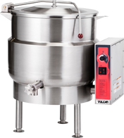 A large, stainless steel stationary kettle with a 40-gallon capacity, featuring a round body on four legs, a hinged lid with handle, side spout, and a Vulcan control panel with red dial, switches, and warning labels.