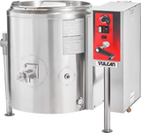A large stainless steel 40-gallon tilting kettle with a control panel labeled “Vulcan” sits on the right. The gas-powered unit features red and black detailing, a temperature dial, switches, levers, spout, side handle, and clear instruction labels.