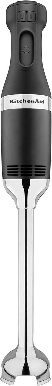 A black and silver KitchenAid immersion blender with control buttons on the handle, a sleek cylindrical body, and a stainless steel blending arm ending in a protective blade guard, shown vertically on a white background.