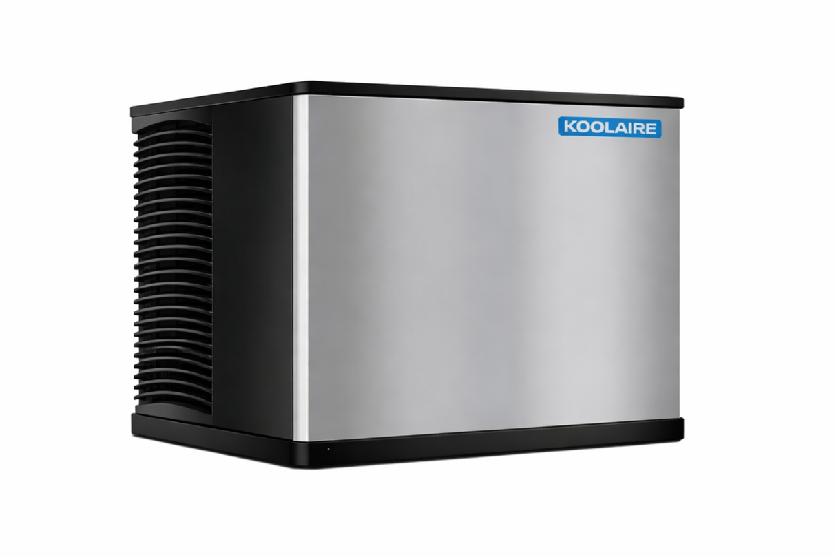 A stainless steel Ice Kube Machine with black trim and vented panels on one side. The front displays a blue rectangular KOOLAIRE logo in the top right corner. This high capacity ice machine stands alone against a white background.