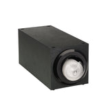 A rectangular black electronic device with a glossy circular lens on the front, resembling a stackable lid dispenser or projector. The matte body features visible screws on the corners. The spiraled lens shows a faint reflection and subtle industrial design.