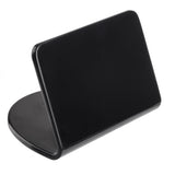 A black, rectangular Buffet Tent with rounded edges stands upright on an oval base. Made from smooth melamine, its simple and modern design by TableCraft is photographed against a white background.