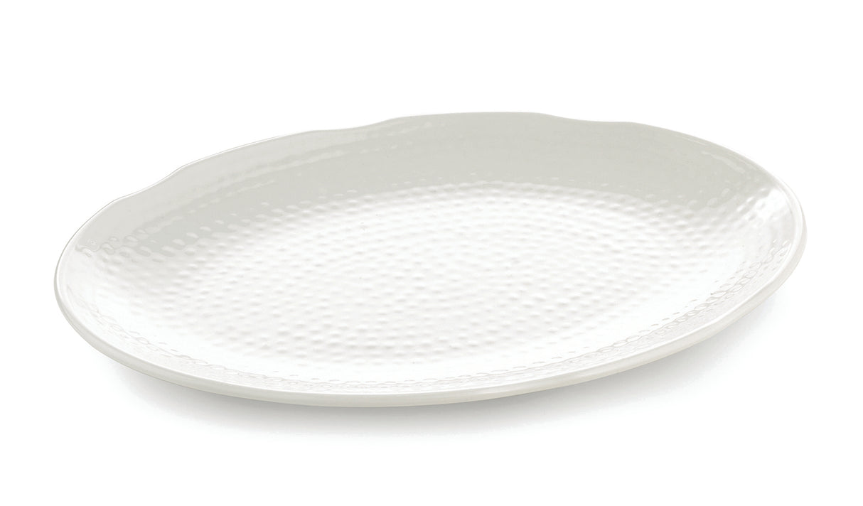 A large, oval-shaped white Frostone Collection melamine tray with a subtle, textured dimpled pattern and a slightly scalloped rim, photographed on a plain white background. The dishwasher safe tray is empty and angled slightly to the left.
