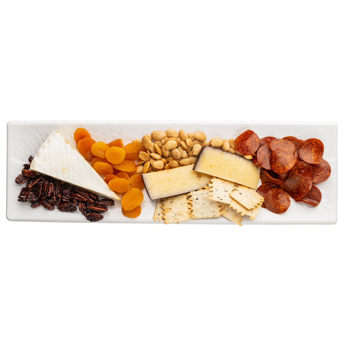 A rectangular white Frostone Collection Dish displays sliced salami, two kinds of cheese wedges, square crackers, whole almonds, dried apricots, and glazed pecans—all arranged neatly in rows.
