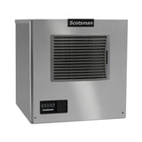 A stainless steel Scotsman ice maker with a front-facing black air-cooled vent, control panel with buttons and indicator lights on the lower left, and a prominent company logo at the top center. The design is boxy and industrial.