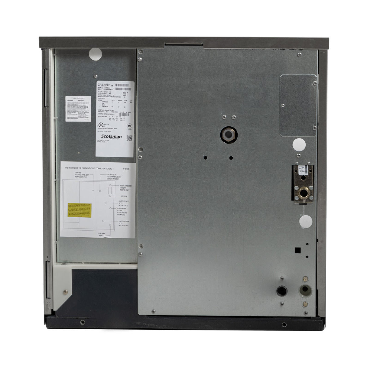 Rear view of a metallic, cube style dishwasher showing a large flat metal panel with labels, wiring diagram, and specifications on the left side, various small circular openings for an ice maker or water-cooled connectors on the right, all within a rectangular frame.