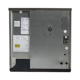 Rear view of a metallic, cube style dishwasher showing a large flat metal panel with labels, wiring diagram, and specifications on the left side, various small circular openings for an ice maker or water-cooled connectors on the right, all within a rectangular frame.