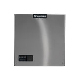 A stainless steel Scotsman Prodigy ELITE® ice maker front panel, featuring a black control panel with buttons and indicator lights in the bottom left corner. The smooth surface has a Scotsman logo at the top center, set against a plain white background.