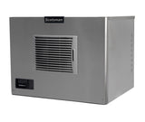 A stainless steel Prodigy ELITE Ice Maker with a horizontal vent grille on the front, a black Scotsman logo nameplate above the vent, and a control panel with indicator lights. This air-cooled ice maker is box-shaped and industrial in design.