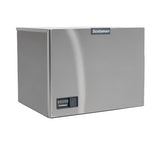 A stainless steel Scotsman ice maker with a rectangular shape, control panel on the lower left front, and the Scotsman logo at the top center of the front panel. This cube style, water-cooled machine features a smooth, slightly reflective surface with minimal detailing.