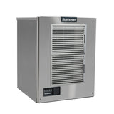 A stainless steel Prodigy ELITE Ice Maker with a rectangular, boxy shape, two large front ventilation grilles, a small control panel with buttons and digital display at the bottom left, and the Scotsman logo at the top center.