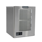 A stainless steel Prodigy ELITE Ice Maker with a rectangular, boxy shape, two large front ventilation grilles, a small control panel with buttons and digital display at the bottom left, and the Scotsman logo at the top center.