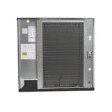 A large, rectangular metal unit stands upright like an air-cooled ice maker. The front features a dark grille of tightly spaced coils with a metal border. A left compartment contains labels and wiring schematics; the side has small holes and a brass pipe fitting.
