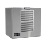 A stainless steel Prodigy ELITE Ice Maker by Scotsman features two large vented panels on the front, a small control panel with indicator lights in the lower left corner, and the logo above. This air-cooled ice maker has a boxy, industrial design.