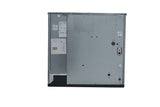 The image shows the back panel of a large metallic appliance, likely a commercial ice machine or dishwasher, with various screws, labels, a circular component, an exposed wiring port, and attached paper documents. The panel is mostly flat with some indents.