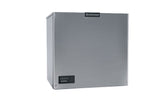 A stainless steel Scotsman Prodigy ELITE ice maker with a square, cube style shape. The front features a small black control panel in the bottom left and the Scotsman logo at the top center, creating a modern, minimalist look against a white background.