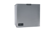 A stainless steel Scotsman Prodigy ELITE ice maker with a square, cube style shape. The front features a small black control panel in the bottom left and the Scotsman logo at the top center, creating a modern, minimalist look against a white background.