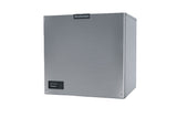 A stainless steel Scotsman Prodigy ELITE Ice Maker with a rectangular shape, a smooth front panel, and a small control panel with buttons and indicator lights in the lower left corner. The medium cube ice machine logo is centered at the top. Plain white background.