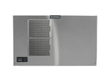A stainless steel Prodigy ELITE Ice Maker is viewed from the front, featuring two horizontal vented panels on the left side, a black control panel in the lower left corner, and a “Scotsman” logo near the top center. The surface is smooth and metallic.