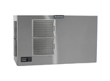 A large, rectangular stainless steel Scotsman Prodigy ELITE ice maker with two vented panels on the front and a control panel at the lower left. The brand name “Scotsman” is displayed at the top. The background is plain white.