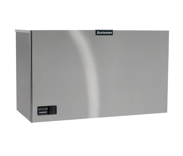 A stainless steel Scotsman commercial ice machine with a rectangular shape, smooth metallic finish, and a small black control panel on the lower left. The Scotsman logo is centered near the top edge. The machine exudes an industrial look.
