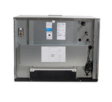 Back view of a Prodigy ELITE metallic microwave oven showing the power cord, installation labels, technical information stickers, ventilation holes, and a silver metal cover. Surface is plain with visible screws and a wiring diagram attached at the center.