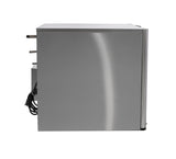 A side view of a stainless steel appliance, possibly a high capacity ice machine or beverage cooler, with a smooth metallic surface. Electrical cords hang from the back, and two protruding metal tubes are visible at the top left. The background is plain white.