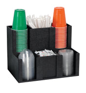 A black cup organizer holds stacks of green, red, and clear plastic cups, white drinking straws, and several sugar or condiment packets, all neatly separated into individual compartments.