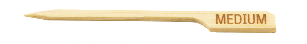 A TableCraft Products Meat Marker Pick made of bamboo, featuring a pointed tip, notched handle, and "MEDIUM" engraved on the right end—ideal for marking food doneness. The background is plain white.