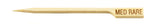 A light bamboo meat marker pick with a pointed tip and a flat, rectangular handle engraved with MED RARE in capital letters, indicating medium rare doneness for foods like steak.