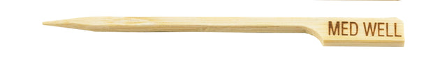 A bamboo meat marker pick with a pointed end and MED WELL engraved on the flat handle, indicating a medium well doneness. The wood grain is visible, and the marker is photographed against a white background.