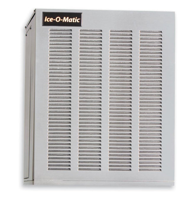 A silver stainless steel ice maker by Ice-O-Matic with two large vented panels on the front, a black and gold logo at the top left, and a boxy design. This water-cooled ice machine is set against a plain white background.